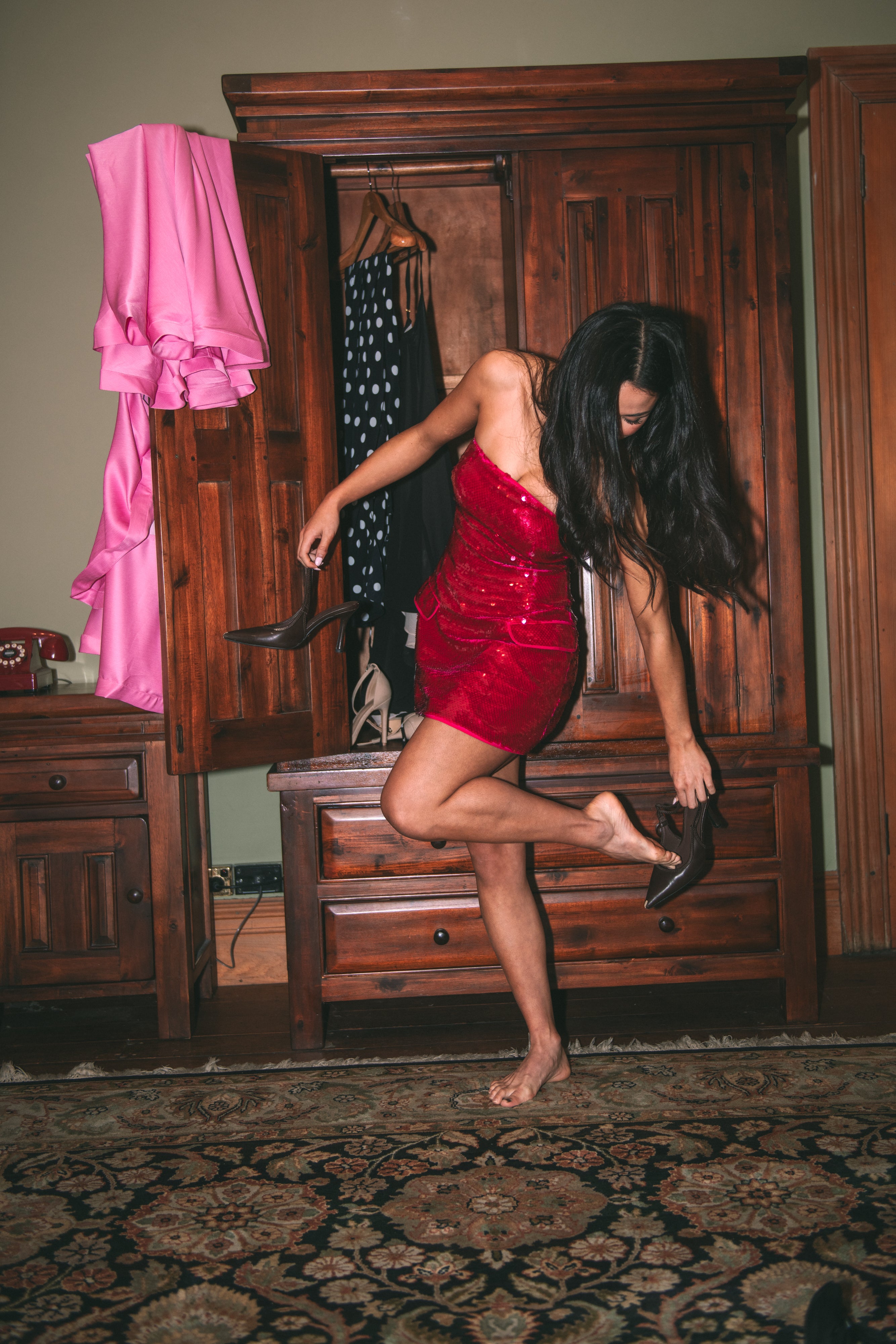 red dress room Elegant Woman in Red Gown Seated Indoors Free Stock Photo